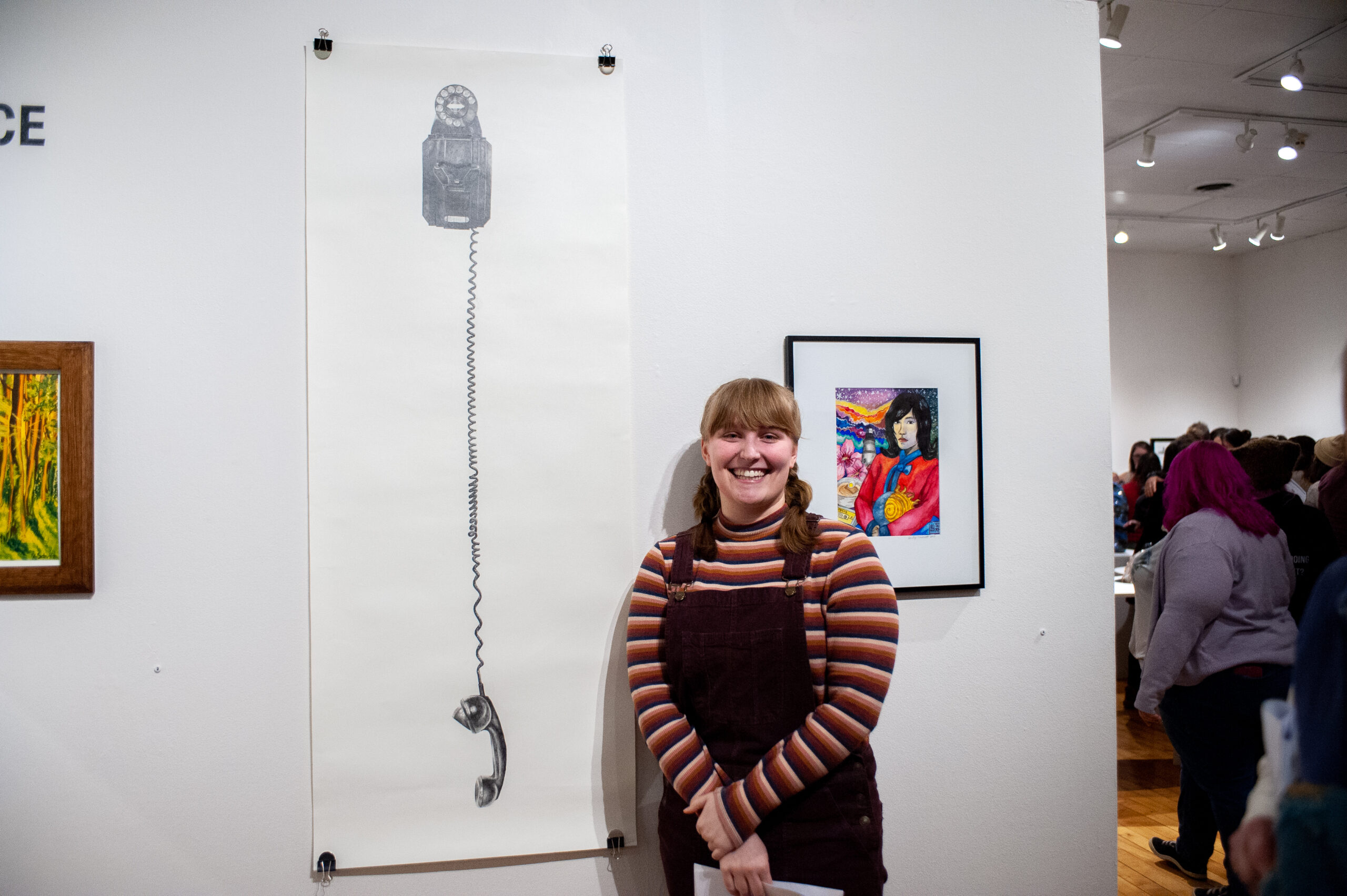 A Student and their piece on exhibit - Courtesy of Will Fudge