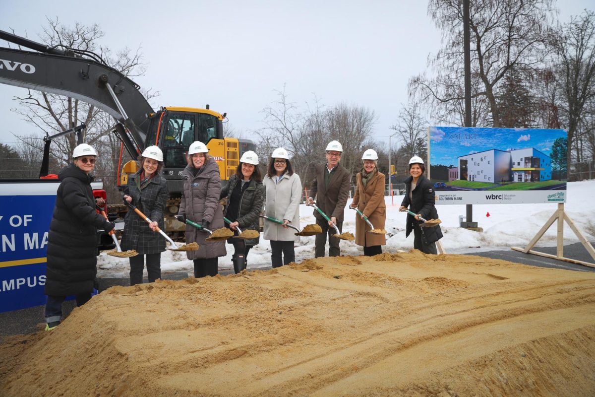 USM administration and faculty stand where the future arts building on the USM Gorham campus will be constructed.